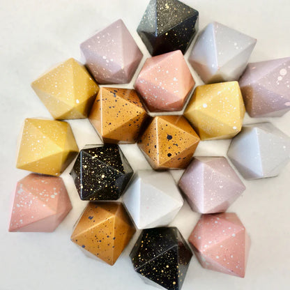 Geometric stone shapes in various colors on a light background